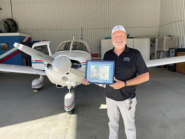 A photo of Larry Rice with his Federal Aviation Administration's Wright Brothers Master Pilot Award