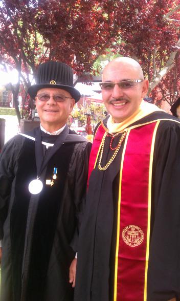 Ray Zacarias on right in gradudation cap and gown from USC