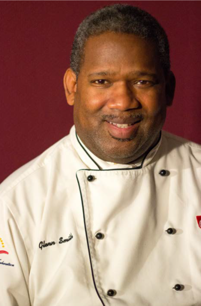 A headshot of Glenn Smith in chef attire.