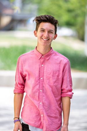 A photo of Andrew Montana in a pink button down