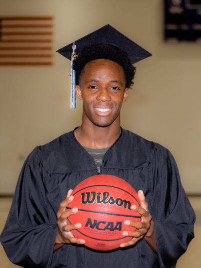 A photo of Chidi Udengwu in a cap and gown with a basketball.