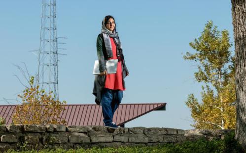 A photo of Sadia Khan standing on a wall at SBVC