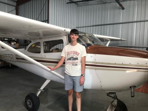 A photo of Zane Rice in front of a plane.
