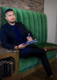 picture of manny sandoval sitting in a chair