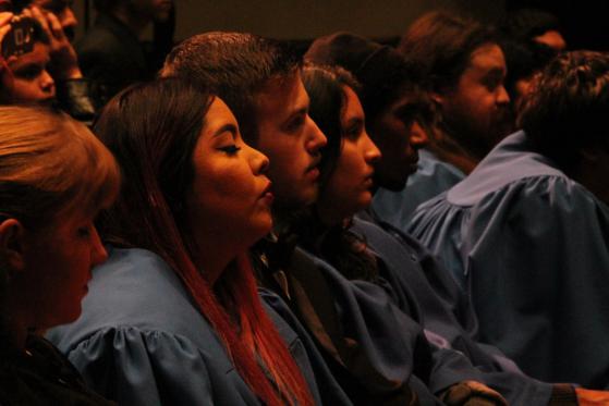 Audience members listen to the combined choir on December 16.