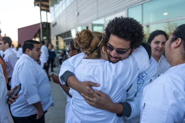 SBVC culinary arts students hug after a stressful competition.