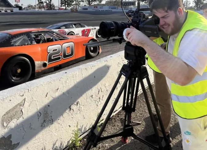 An FTVM student filming race cars