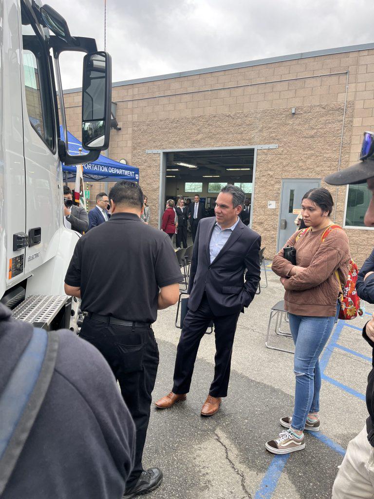 Photo of Rep. Aguilar next to an ev truck