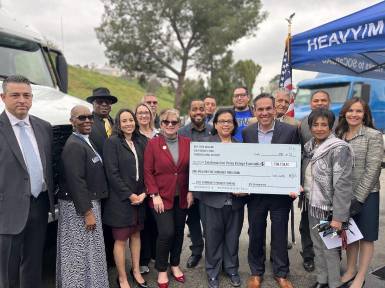 Group photo with Rep. Aguilar holding a check
