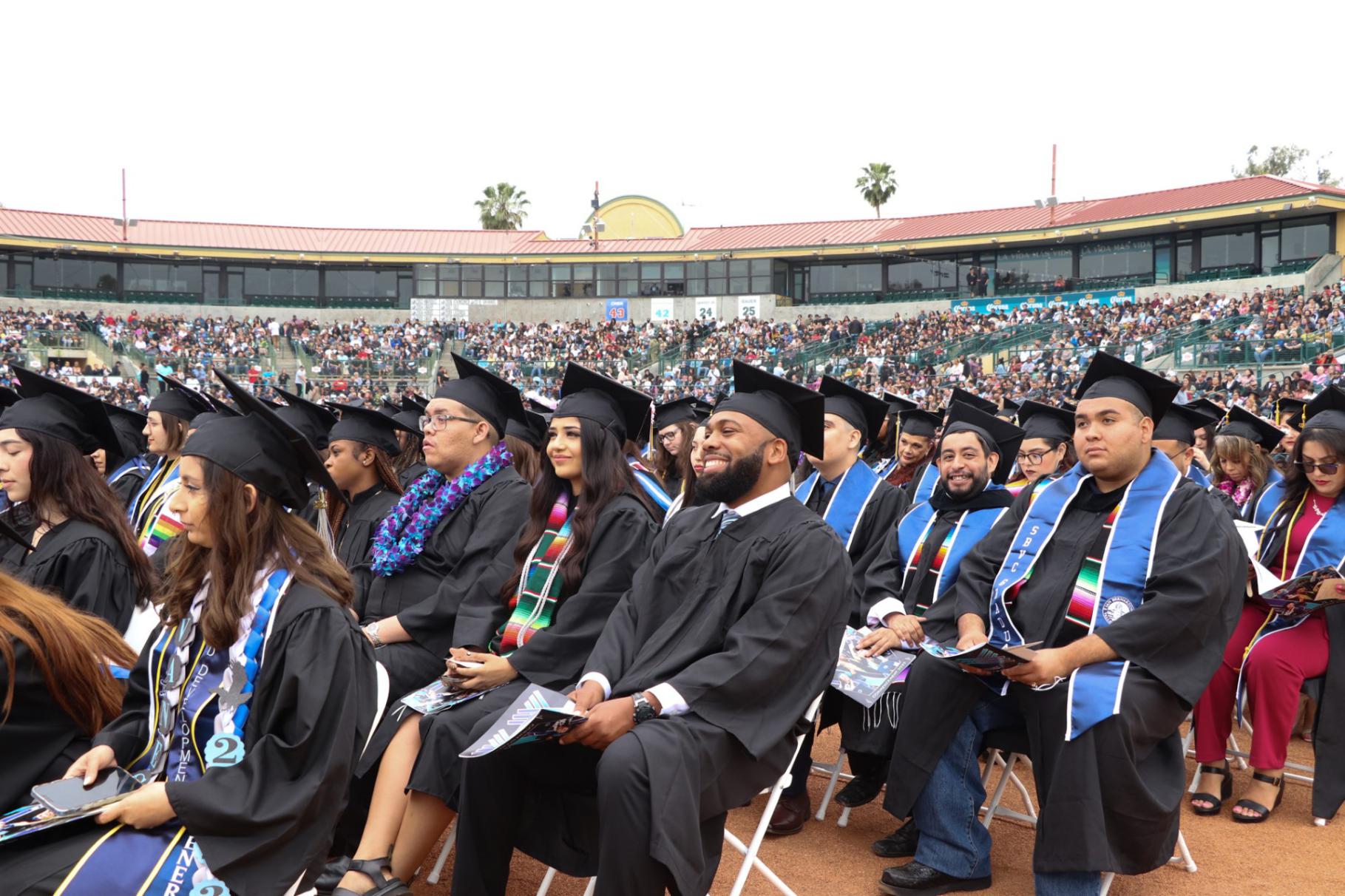 Graduates of San Bernardino Valley College’s Class of 2023 listen to keynote speaker Dr. Louie F. Rodriguez at San Manuel Stadium on May 24, 2023.