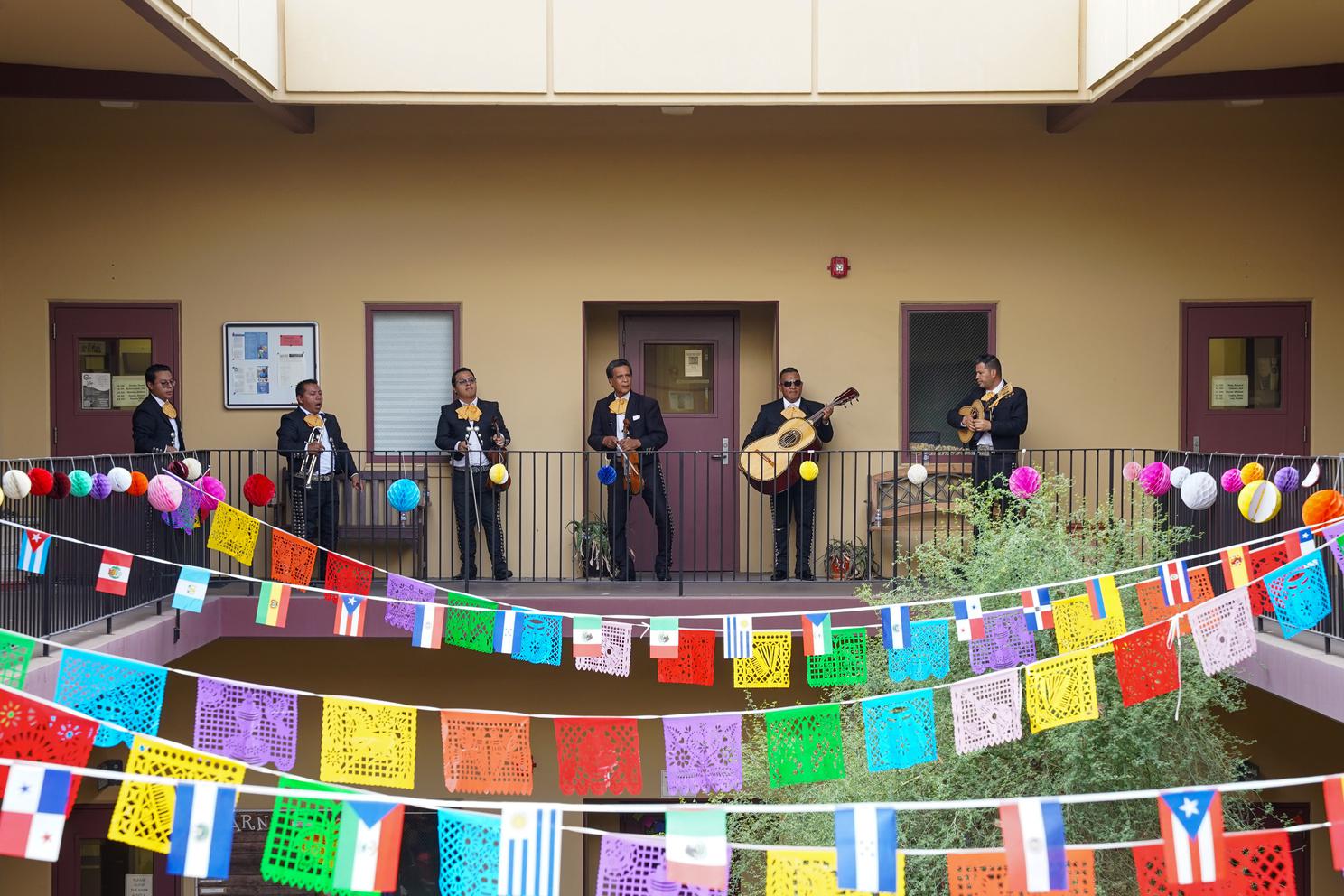A Mariachi band playing above the LA Courtyard
