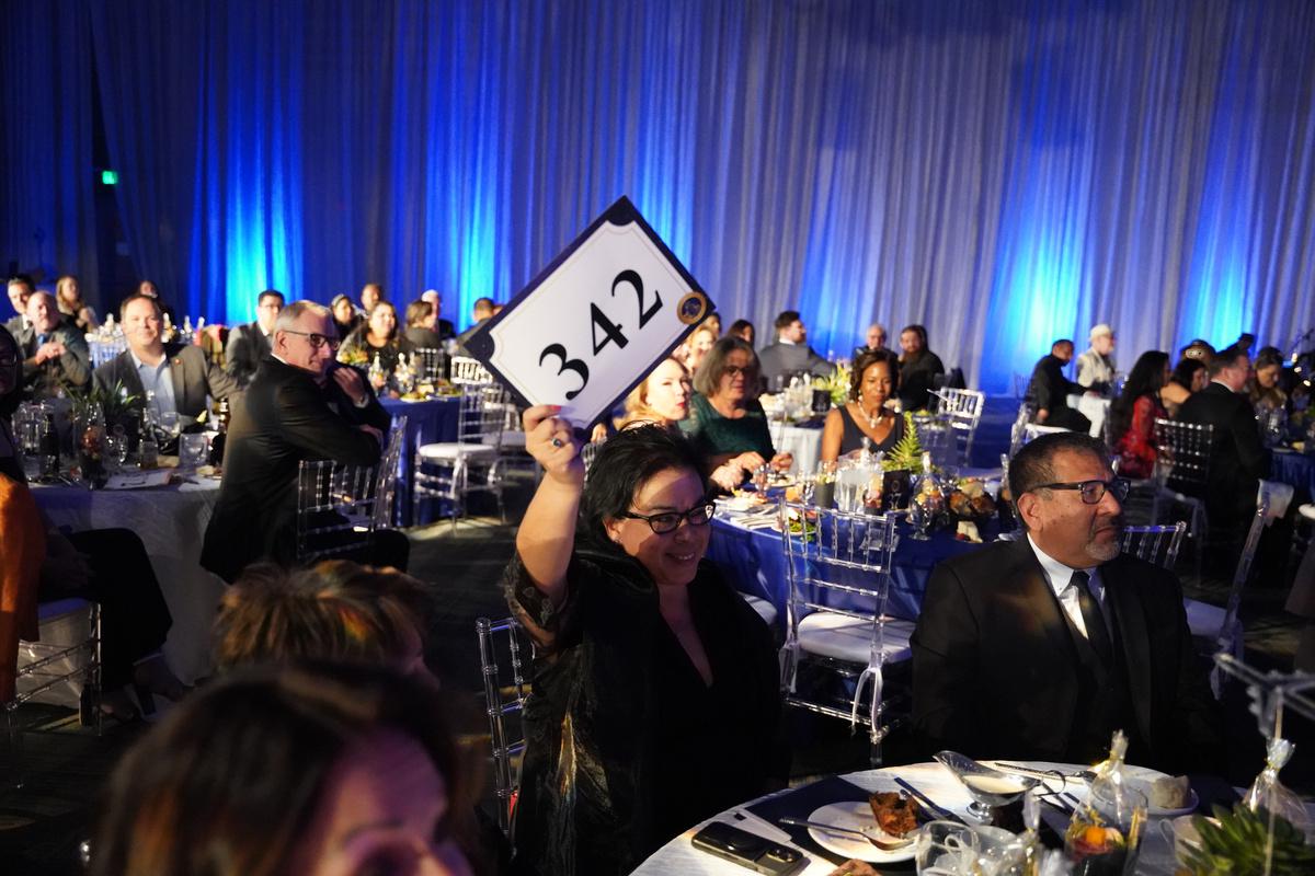 Chancellor Diana Rodriguez voting in the gala auction 
