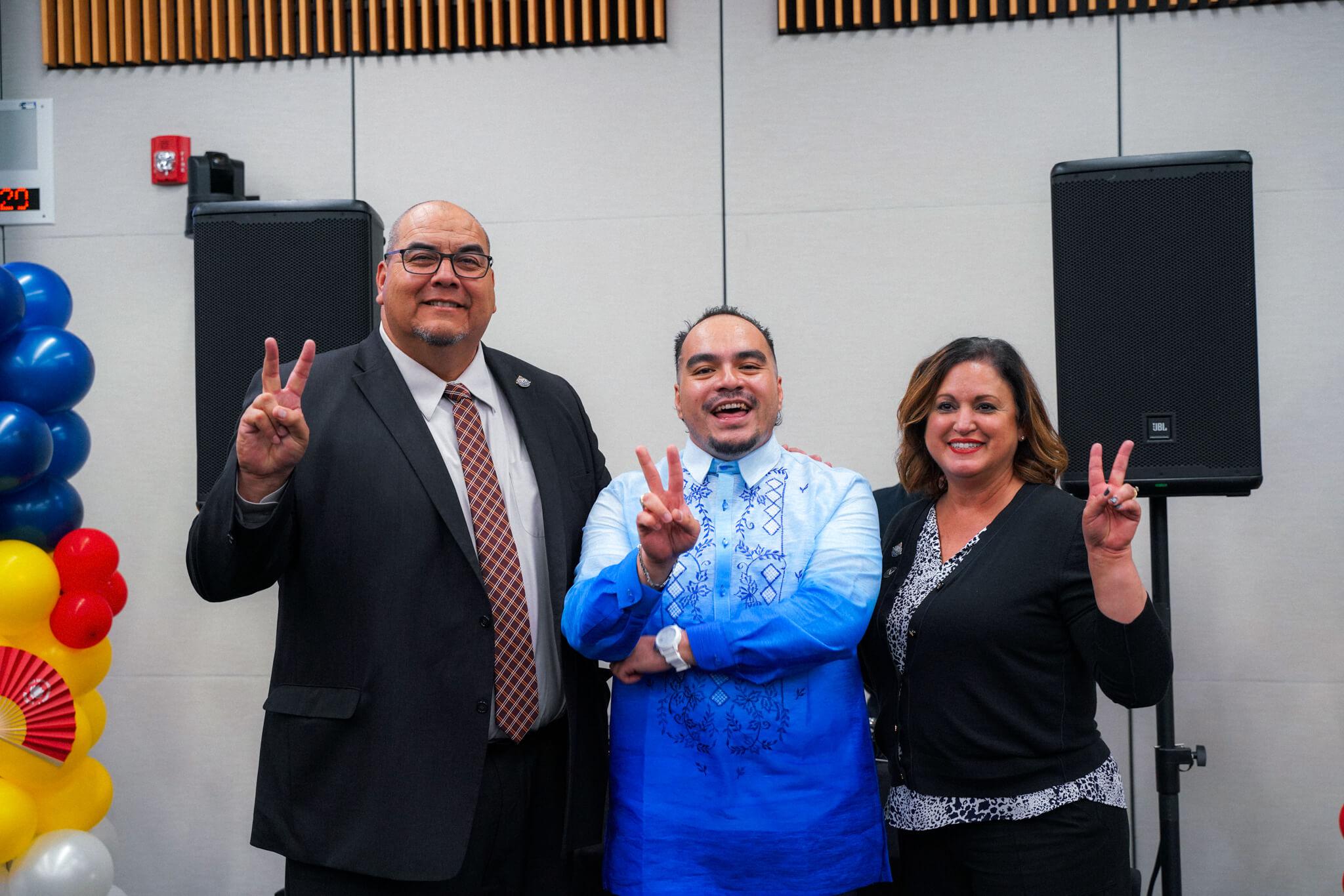 President Dr. Gil Contreras giving the "Valley Up" sign with co-coordinator Rangel Zarate and Leticia Hector