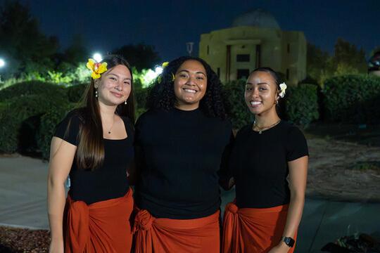 Students standing and smiling