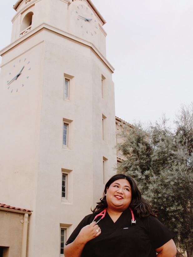 Jaena Sparks posing with a stethoscope under the SBVC Audetorium