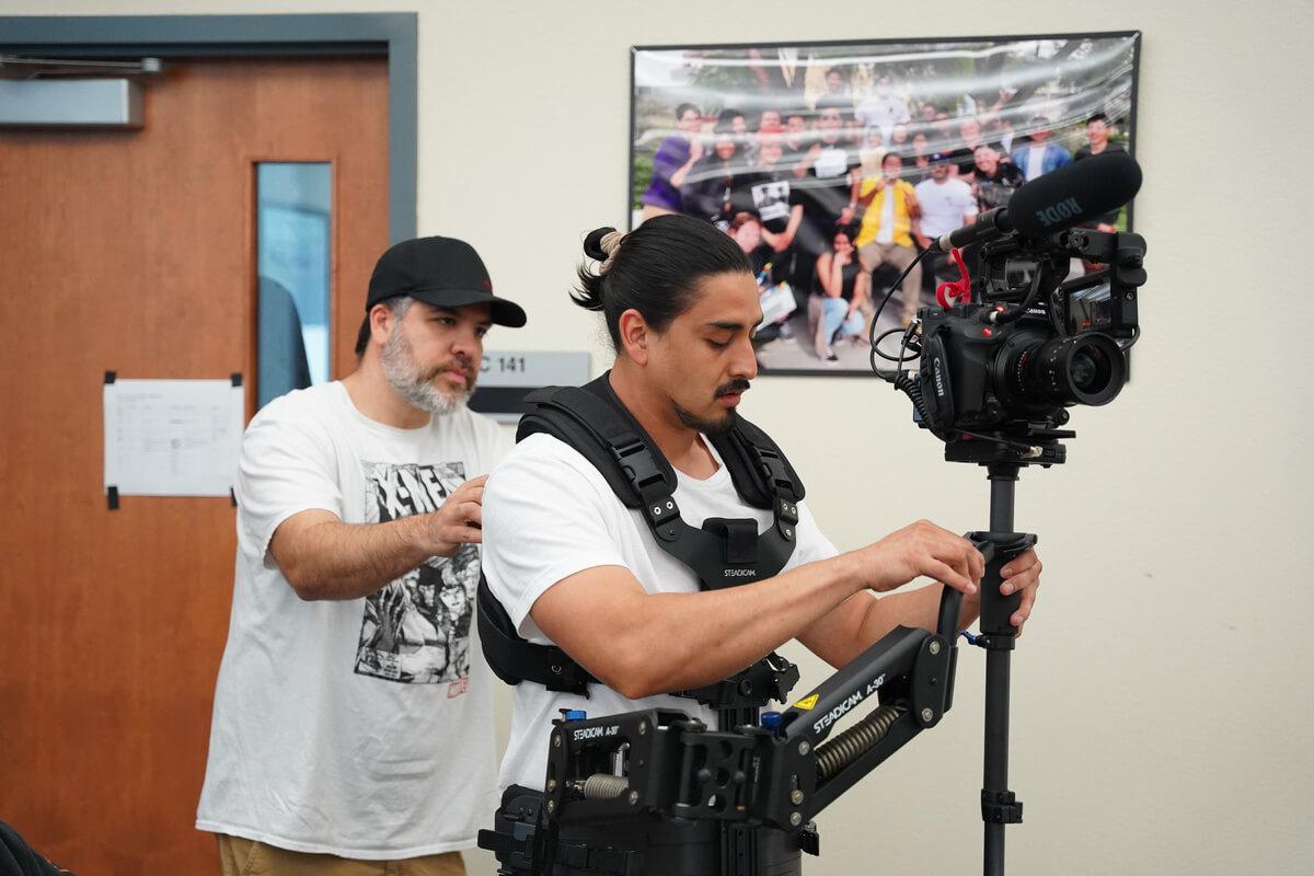 A student in FTVM working with videography equipment