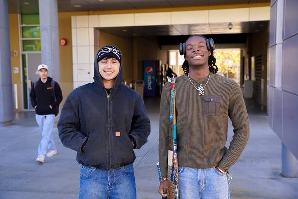 Two students smiling side by side