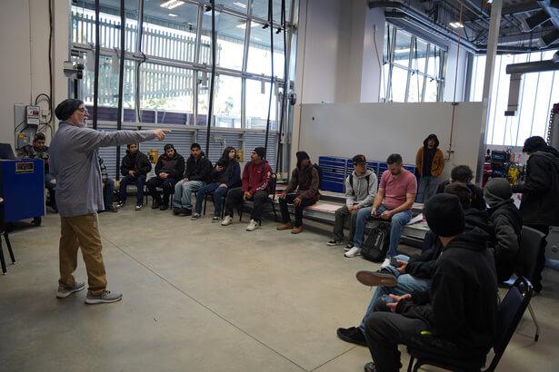 A teacher pointing and asking students questions