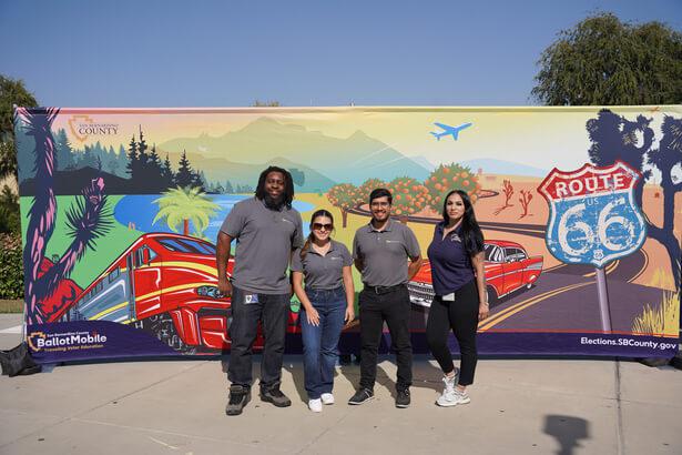 KVCR Staff standing in front of a Route 66 California backdrop
