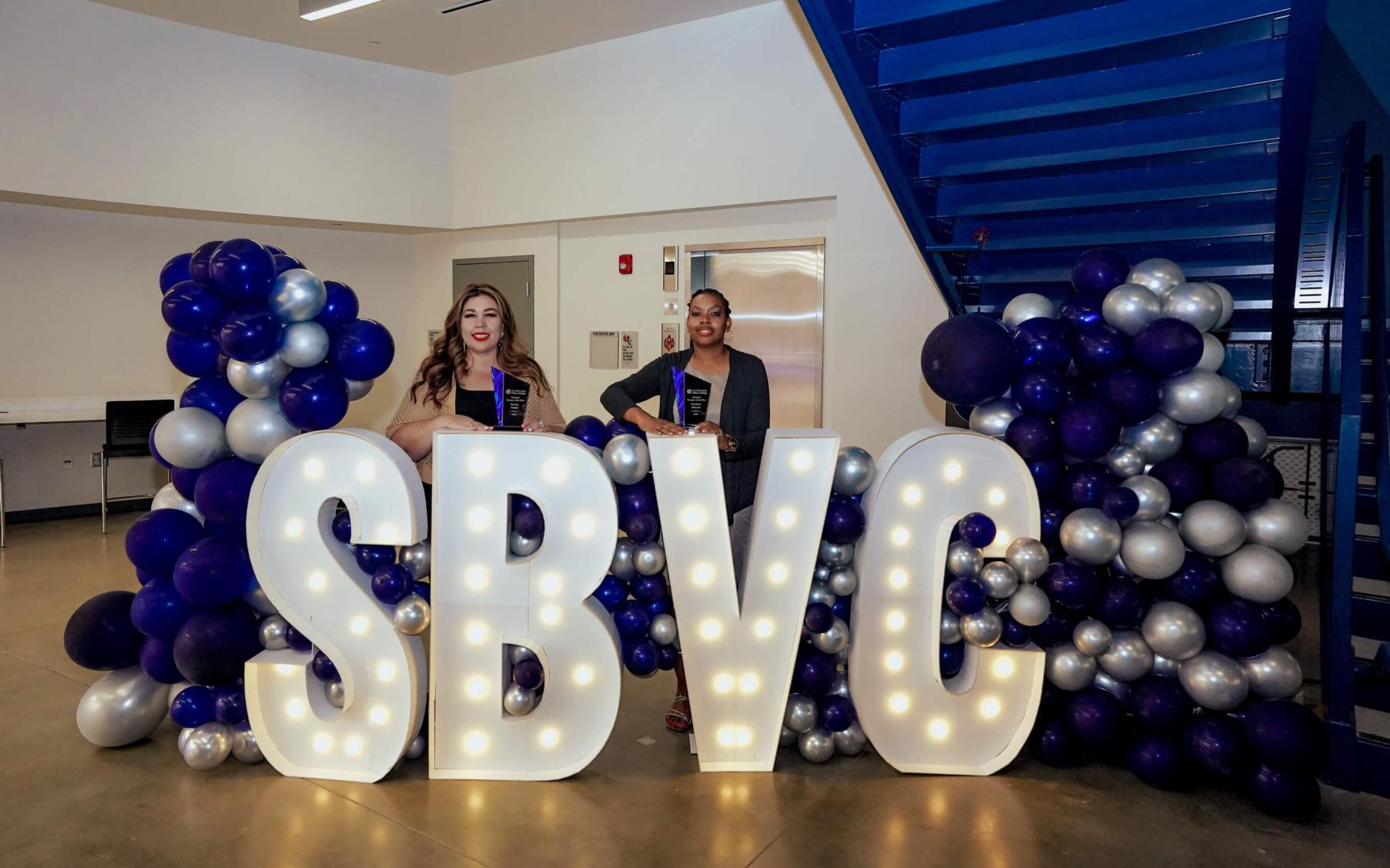 SBVC letters lit up with spotlighting winners in front