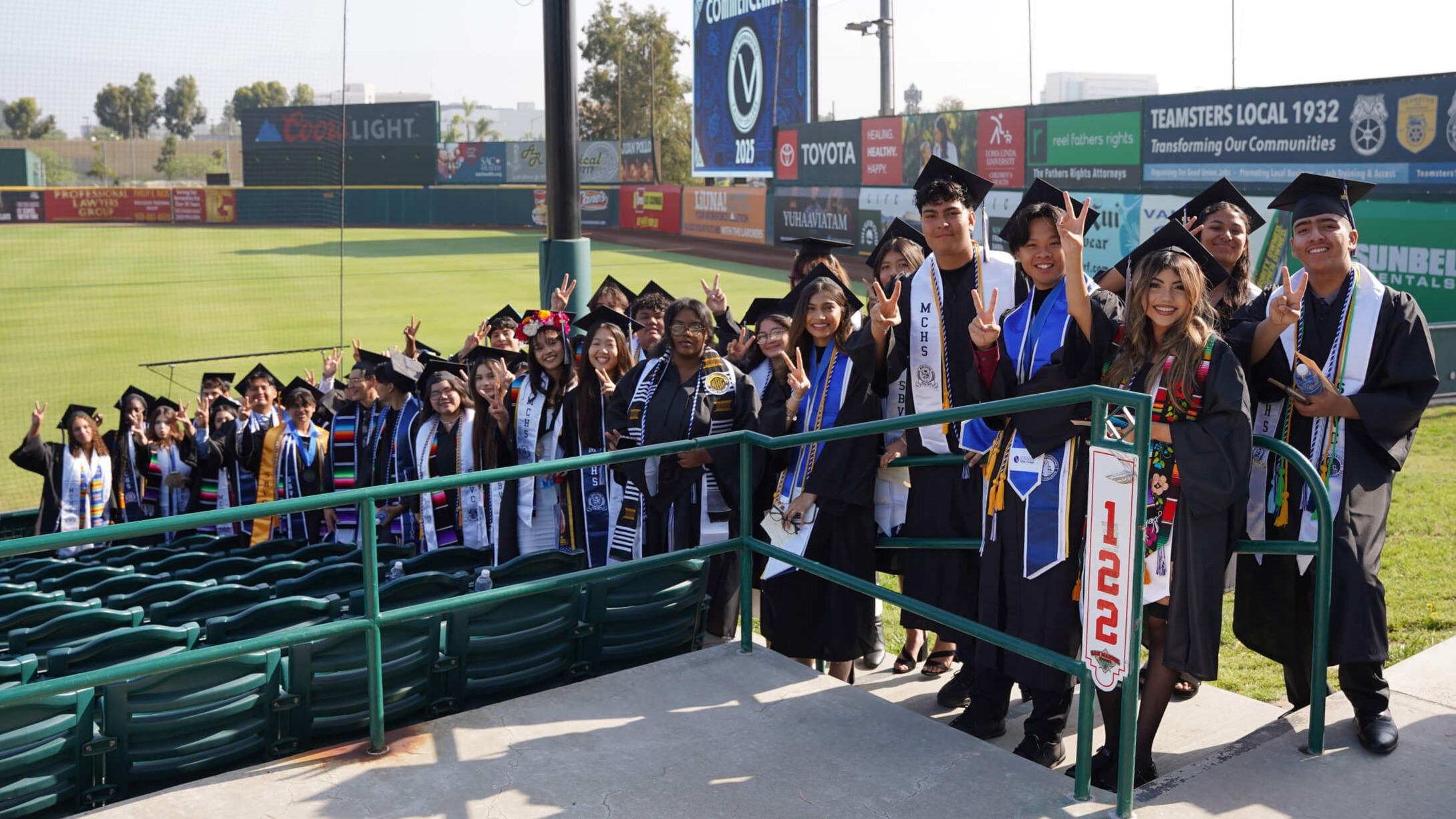 Graduates lined up smiling