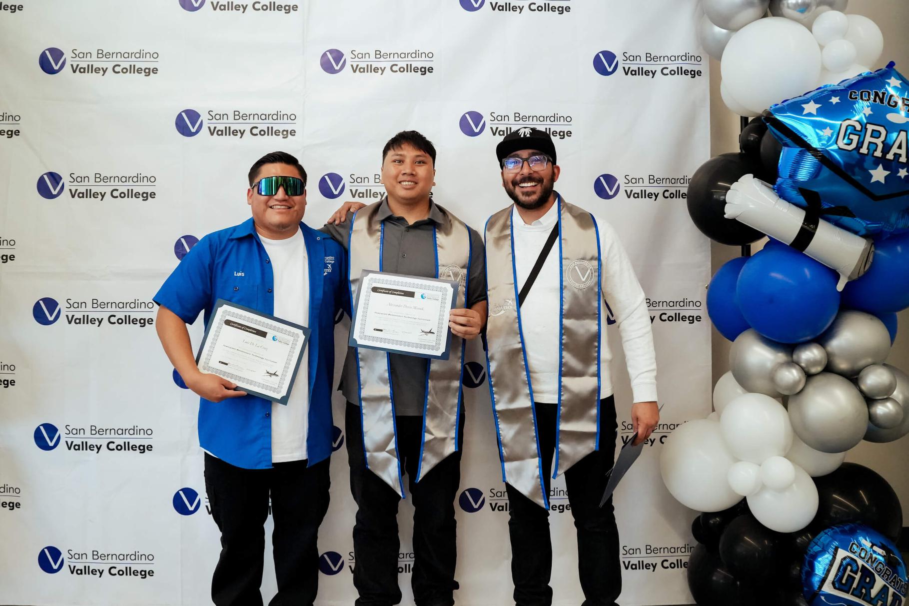 A group of grads smiling and posing