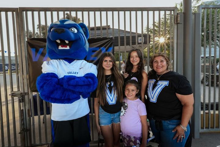 Blue the Wolverine posing with a family