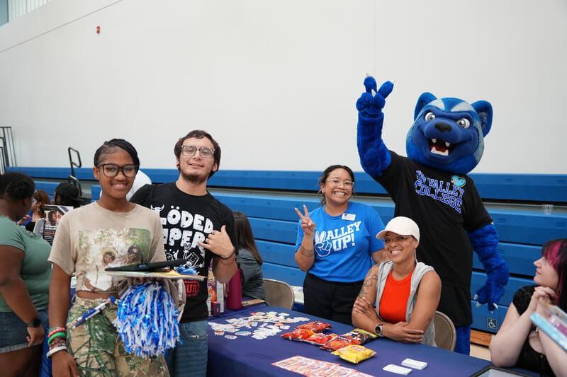 Students at the Wolverine Welcome event posing with Blue