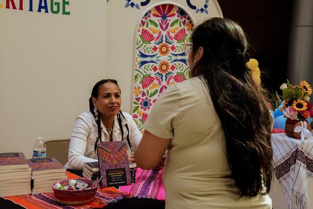 Student speaking with Dr. Gina Garcia