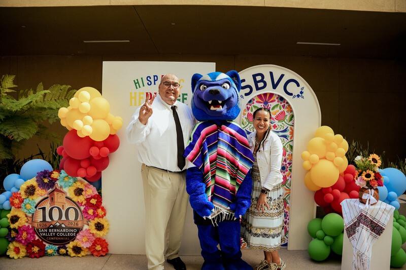 Dr. Contreras and Dr. Gina Garcia posing with Blue the Wolverine