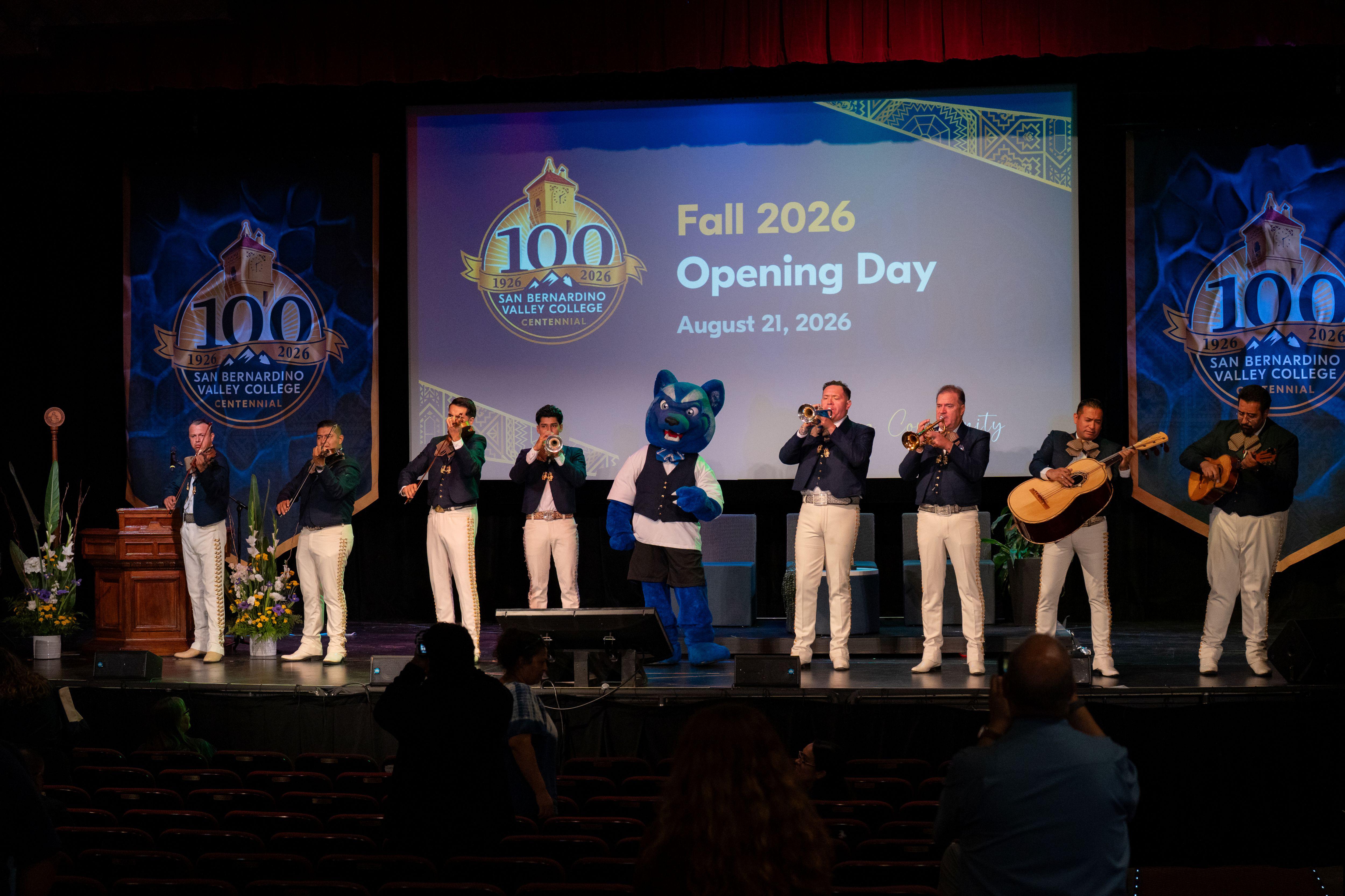 SBVC mascot Blue stands onstage with a mariachi band