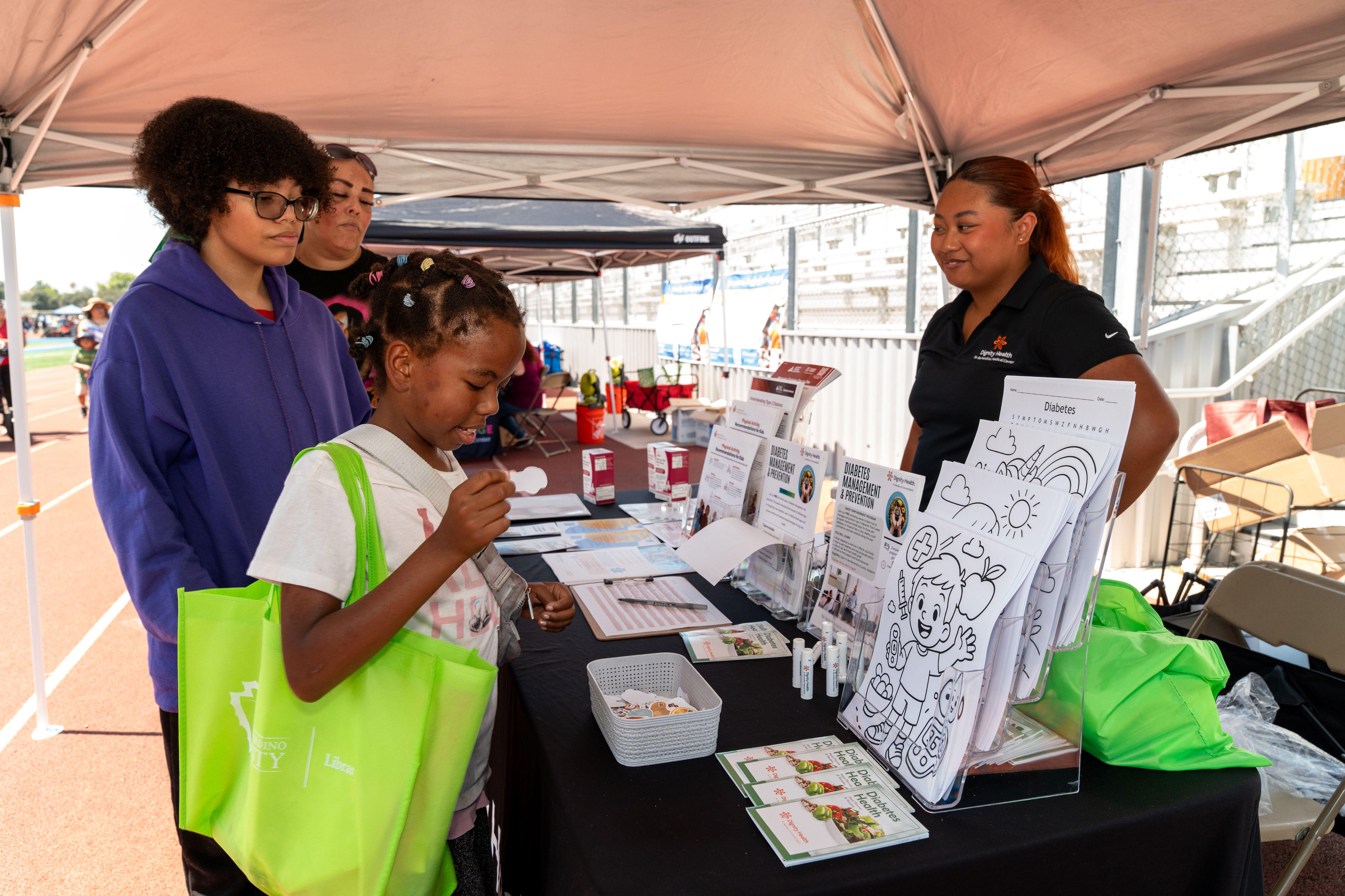 A family visits an information booth