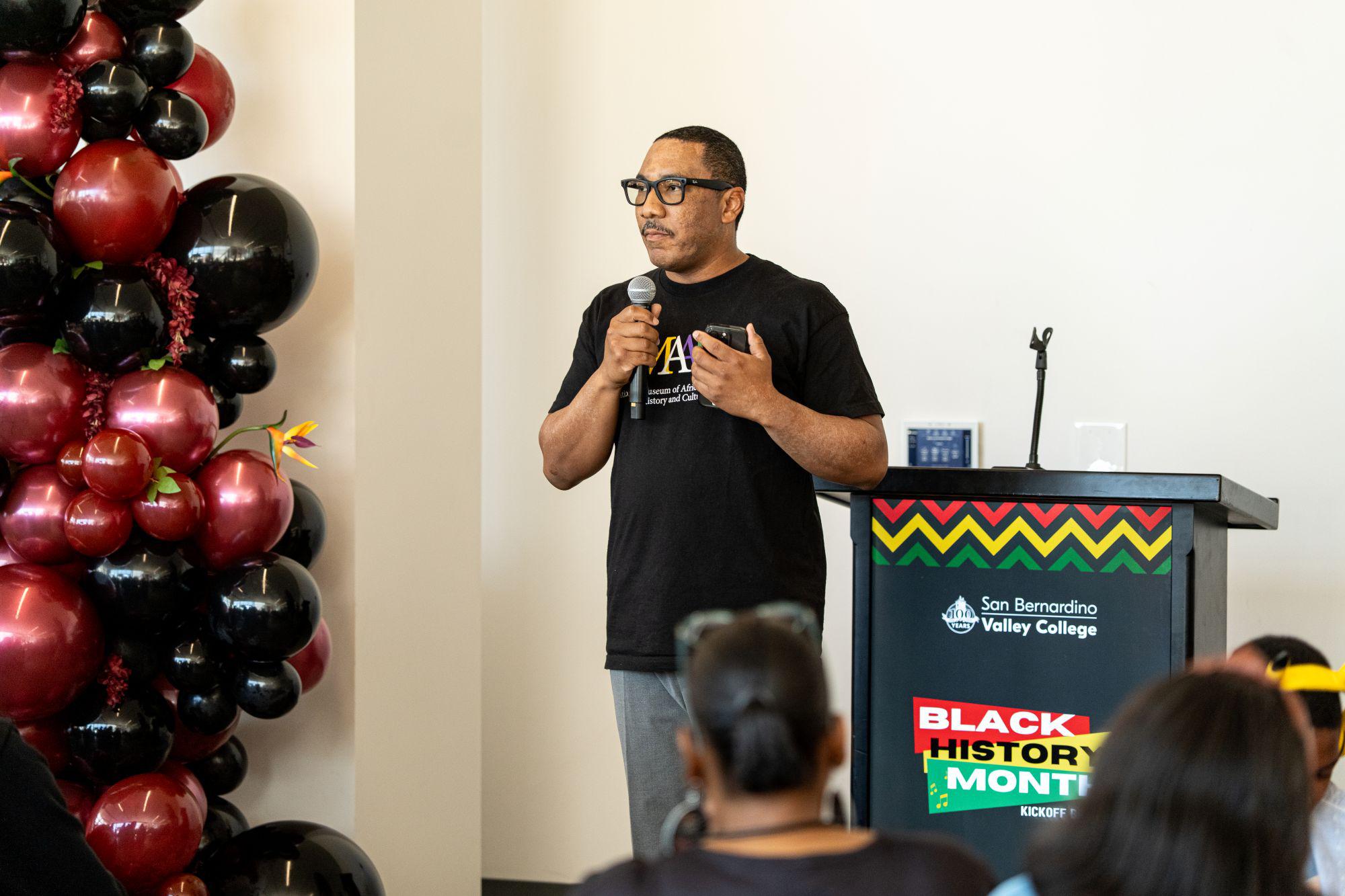 A man speaks at a Black History Month event.