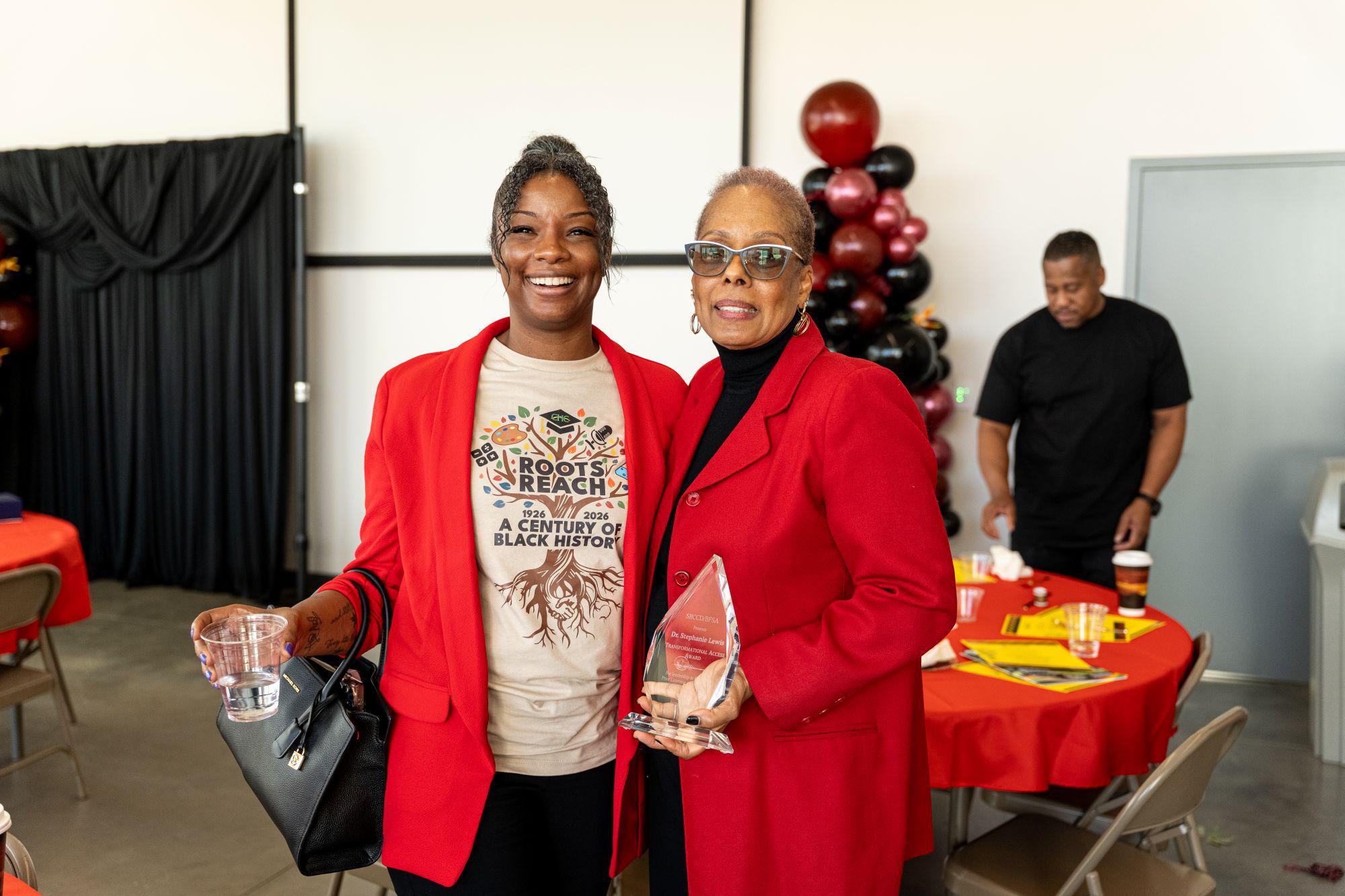 Two women stand together at a Black History Month event