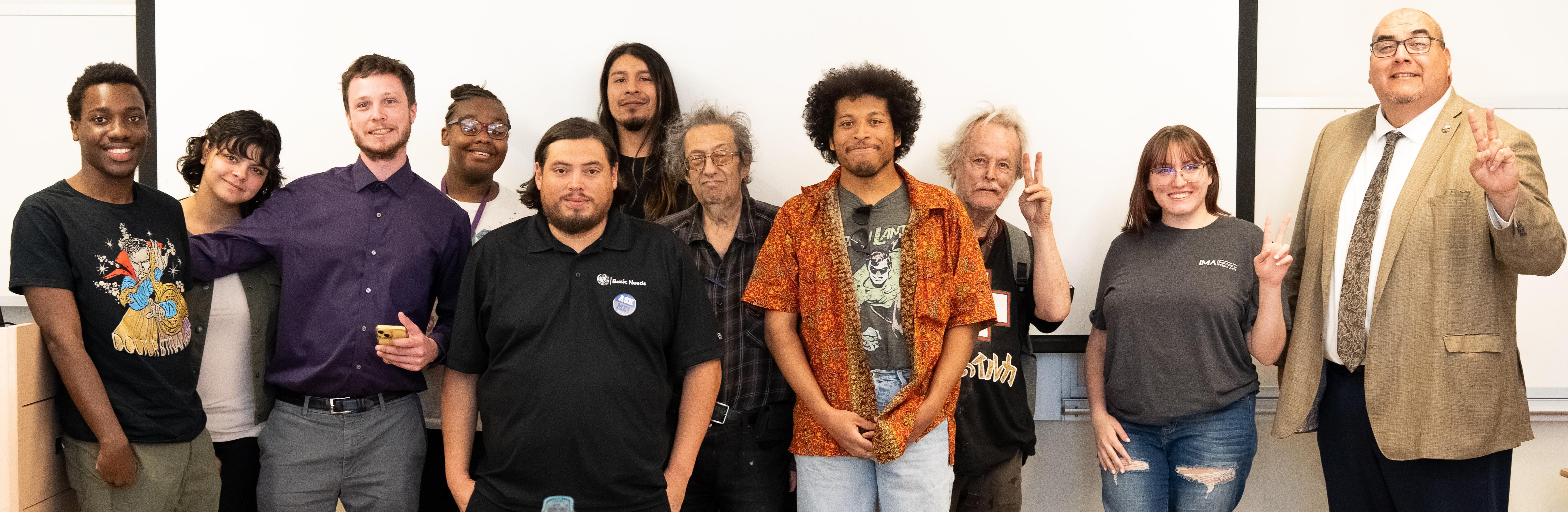 SBVC president poses with students in a classroom