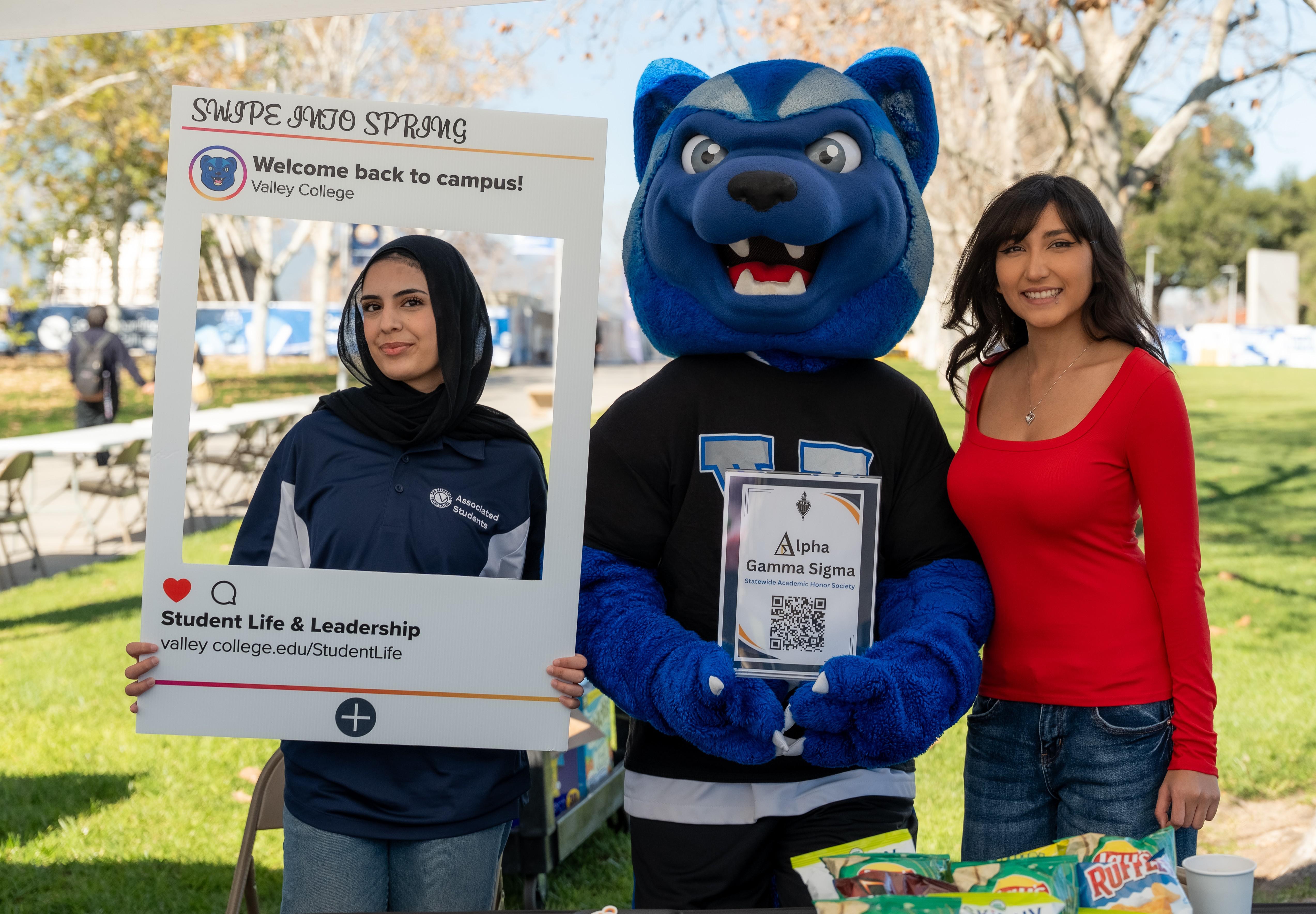 Two students pose with SBVC mascot Blue