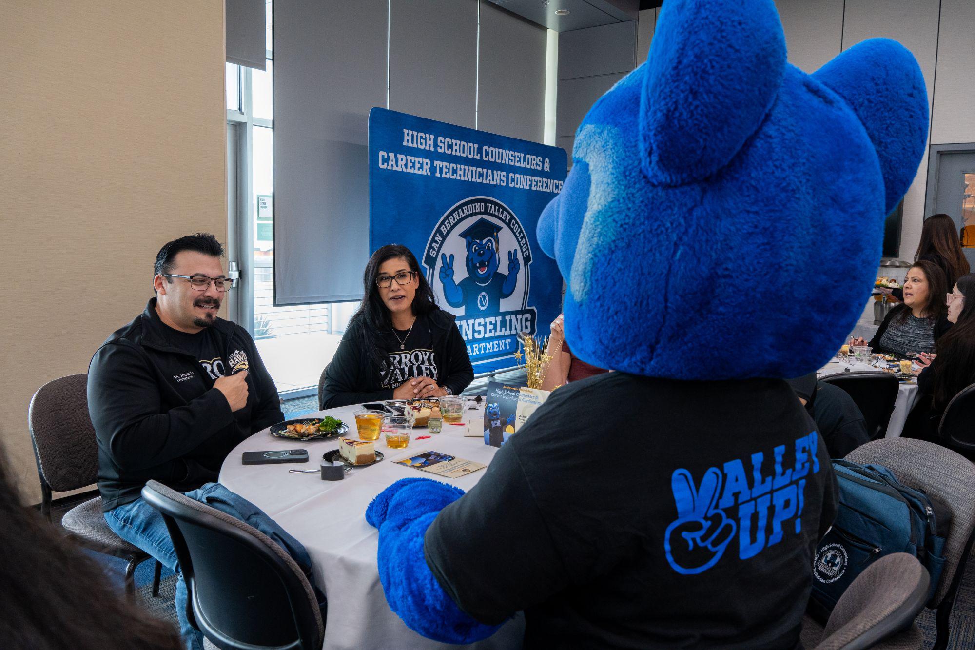 High school counselors talk with SBVC mascot Blue at conference