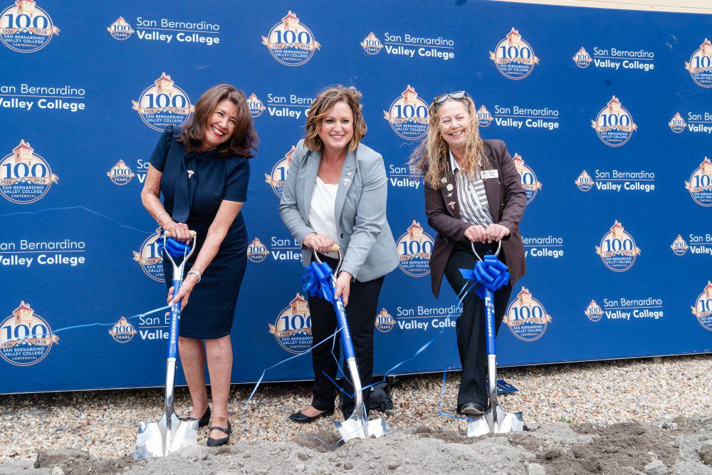 Three women hold shovels