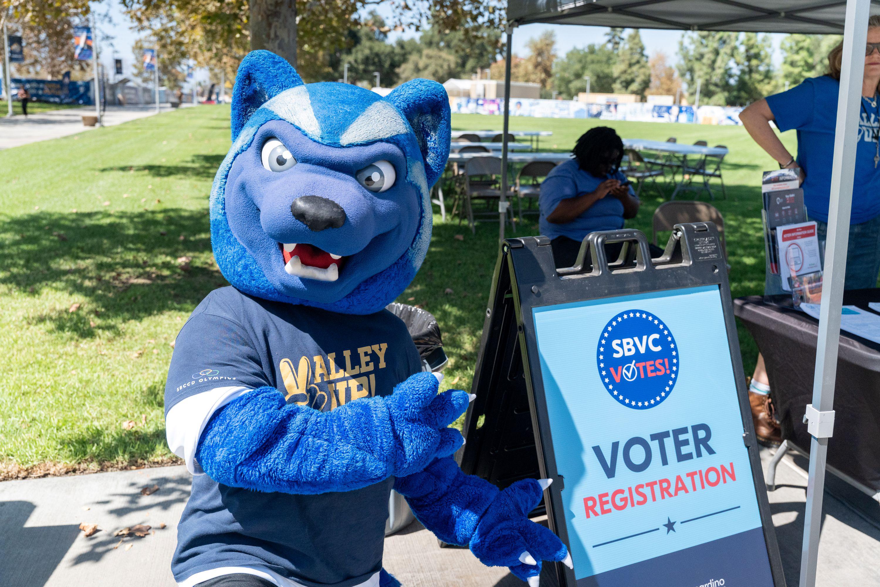 SBVC mascot Blue poses with a voter registration sign