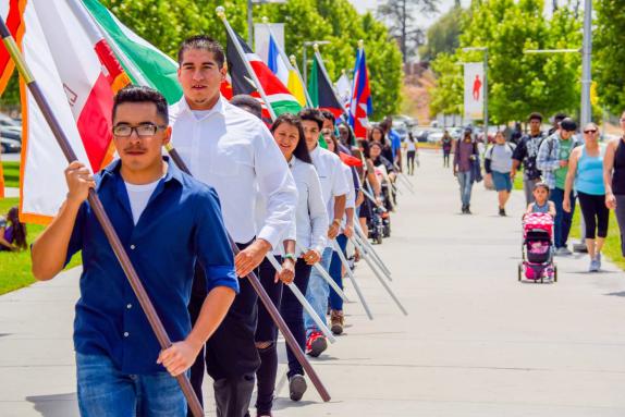 Students walk in a flag parade