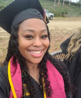 Headshot of Jasmin Smith smiling in graduation cap.