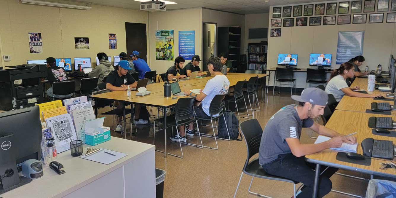 Students work on computers in the huddle