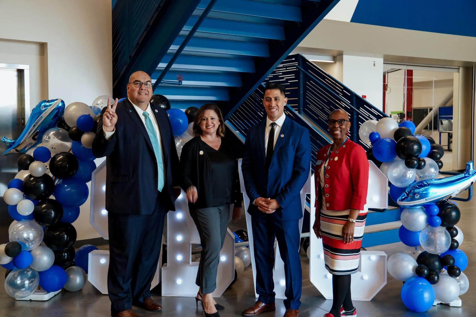 President Contreras with administrators flashing the "Valley Up" symbol