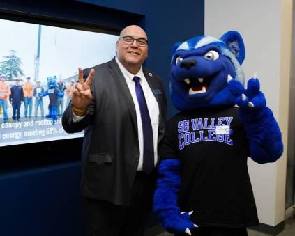 President Contreras and Blue flashing the "Valley Up" symbol