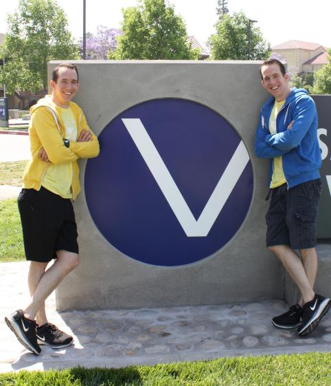 darrell and daniel peeden in front of SBVC v-ball signage